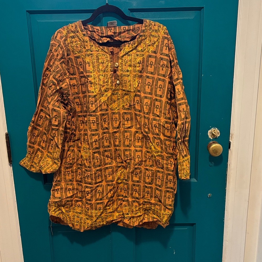 The African Star dashiki? Orange/brown with ankh in olive and yellow embroidery